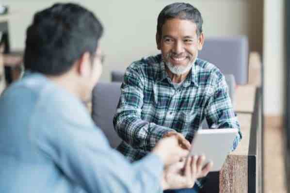 A middle-aged man smiling as he receives foreclosure prevention counseling