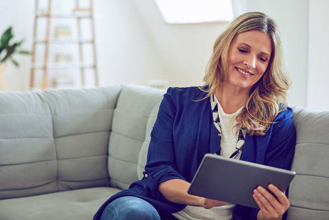 A middle-aged woman signing up for a non profit debt management program