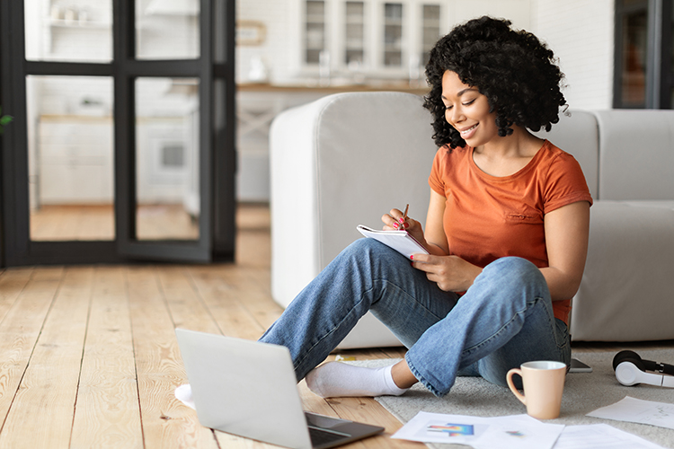 Female Student Using Laptop At Home