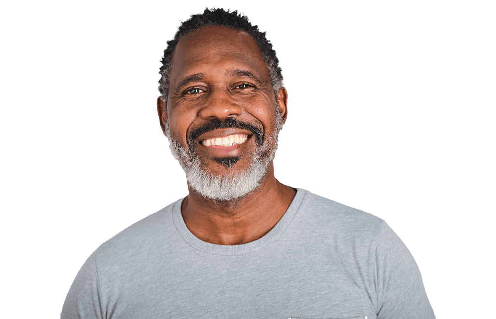 A man with graying hair and a gray shirt smiles.